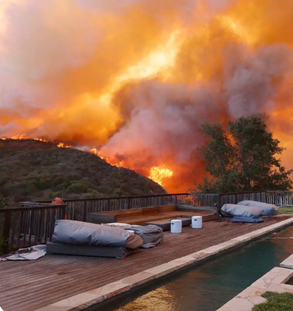 Palisades Fire approaching a hillside property, January 2025